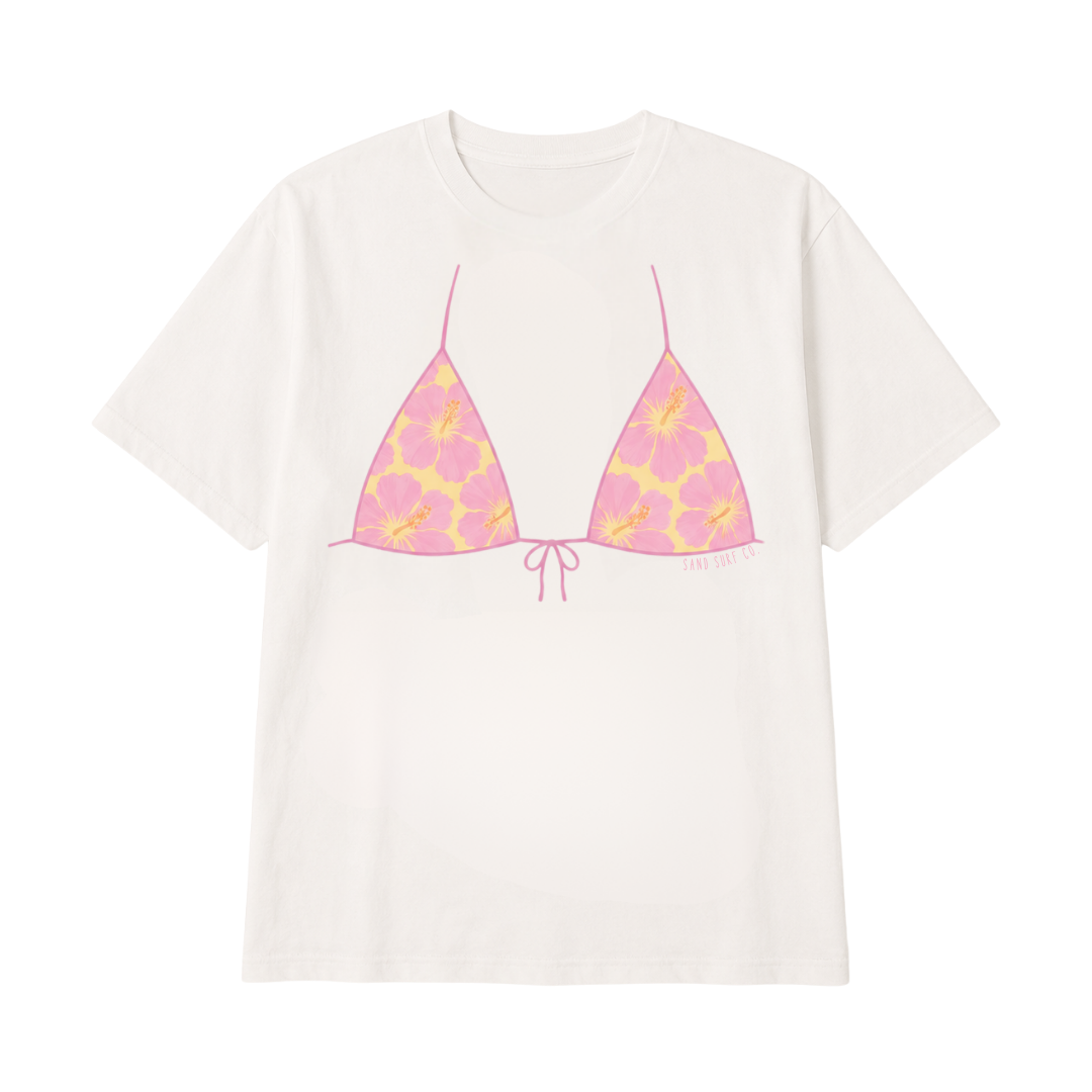 An white short-sleeve t-shirt featuring a graphic print of a pink and yellow patterned triangle bikini top on the front.